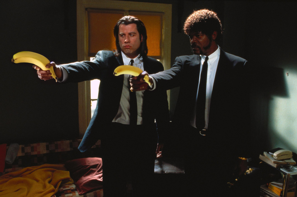 1665180101552-562924531-john travolta in a suit holding bananas and samuel l jackson holding a...png