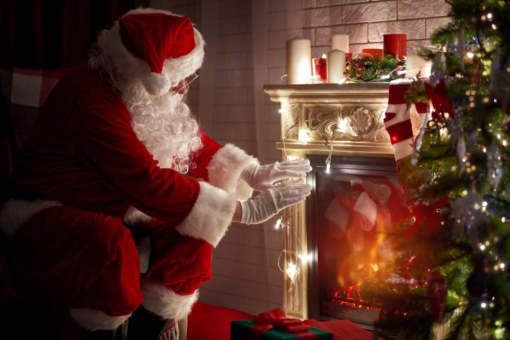 santa-warming-his-hands-at-fireplace-scaled.jpg