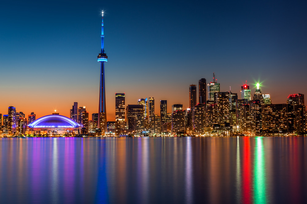 Toronto-Skyline-at-dusk-with-a-reflection-in-Lake-Ontario-Shutterstock.jpg